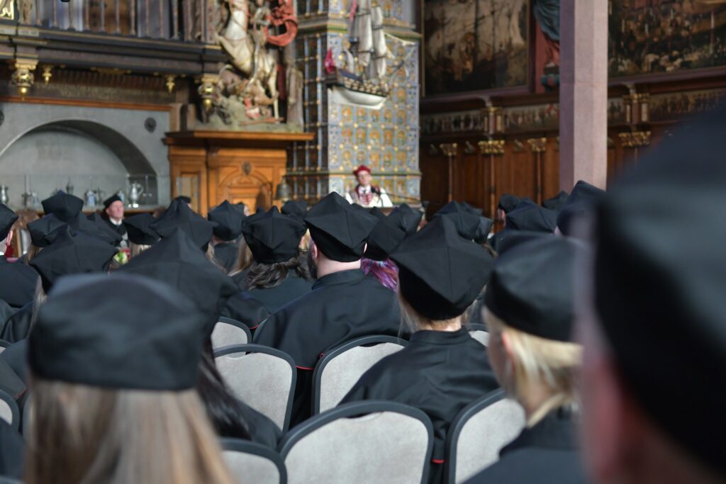 People in graduation caps from the back.