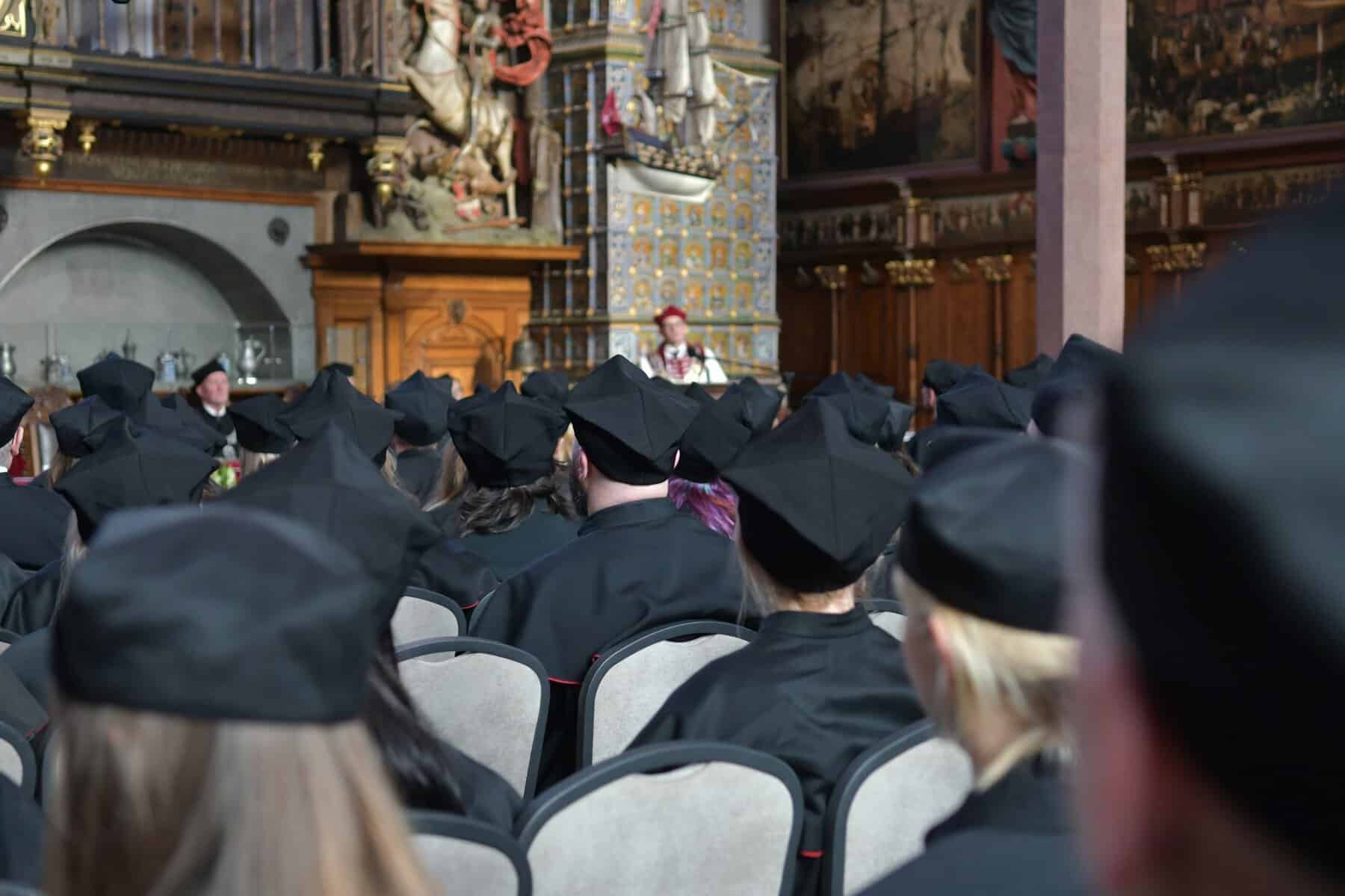People in graduation caps from the back.