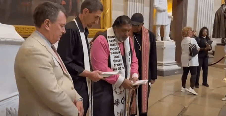 Rev. William Barber praying in the Capitol Rotunda