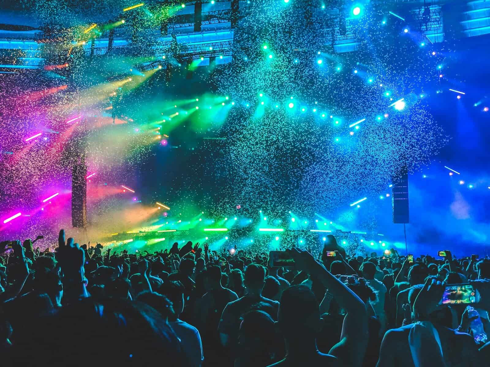 A music festival stage with colored lights.