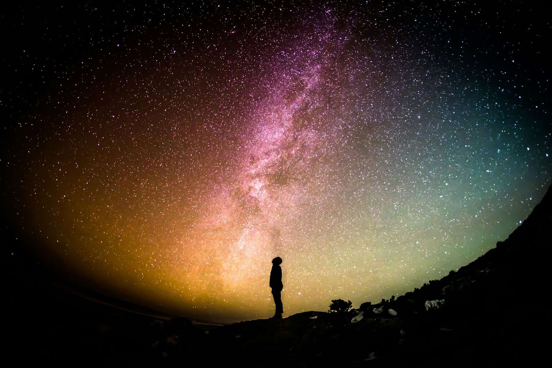 Silhouette of a person looking up to the Milky Way.