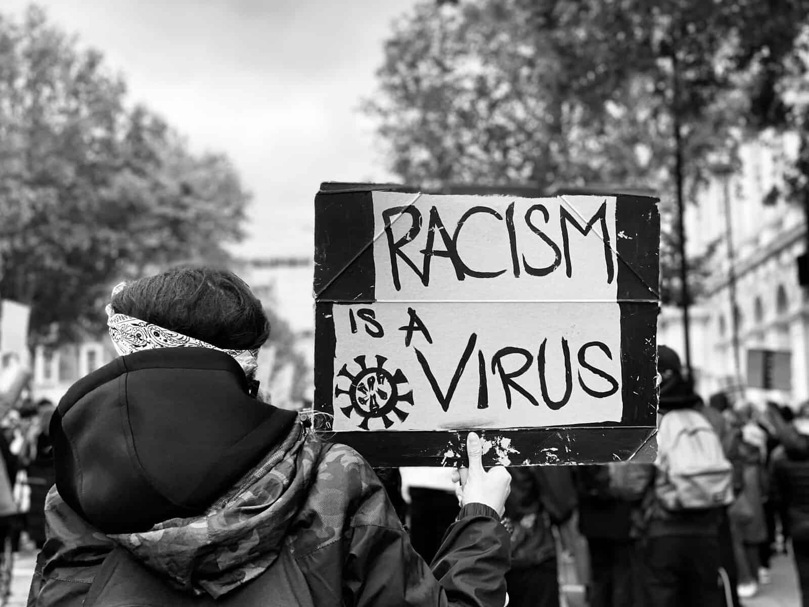 A sign says Racism is a virus