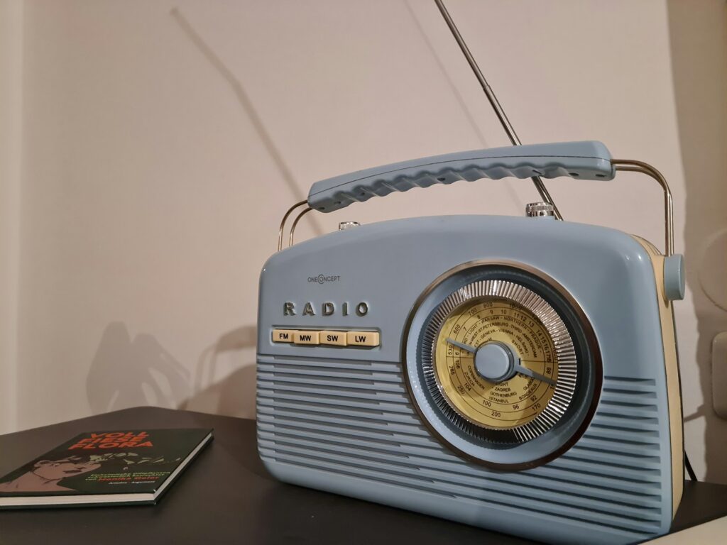 A vintage blue radio on a table.