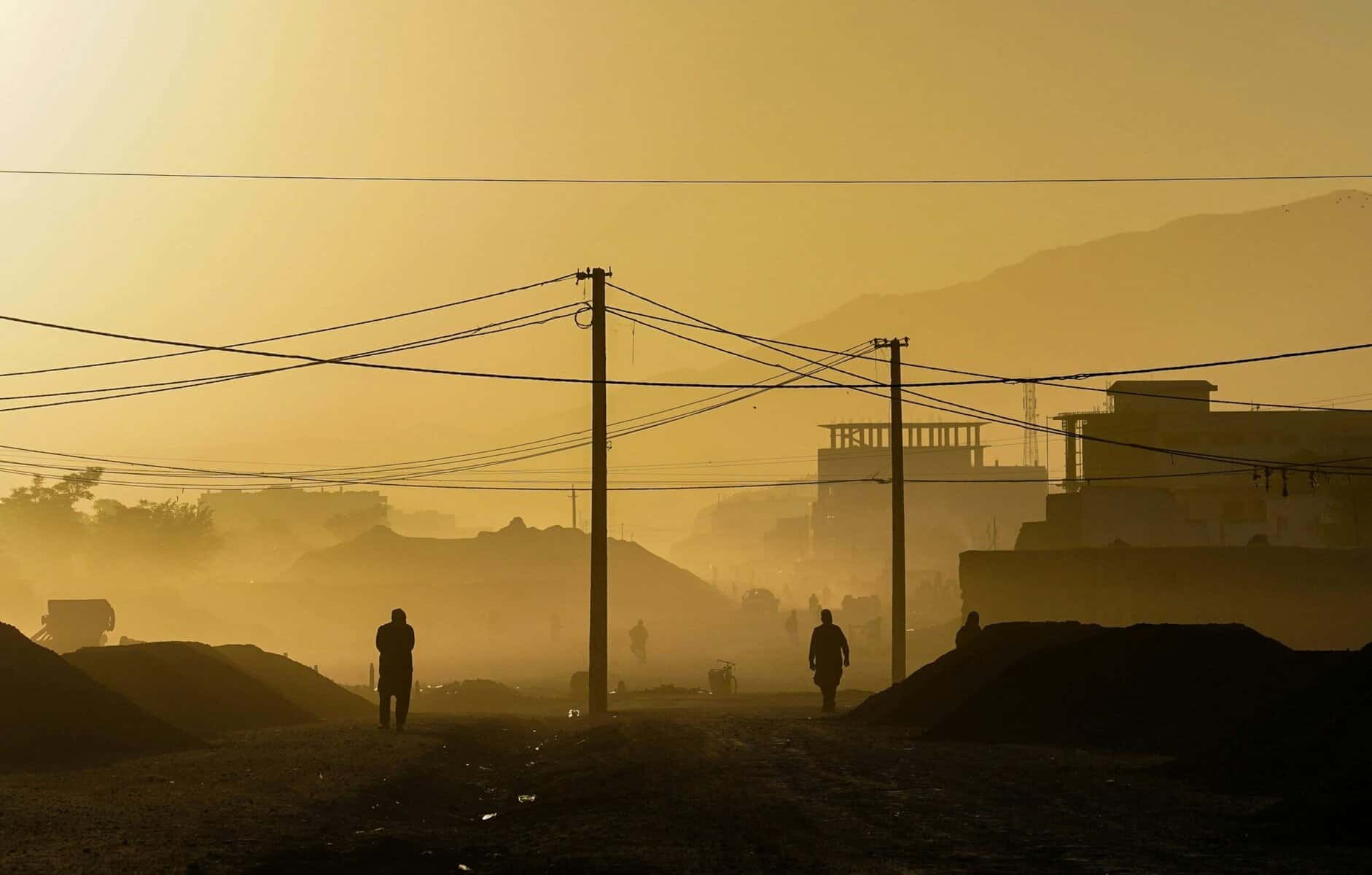 People walking through a haze.