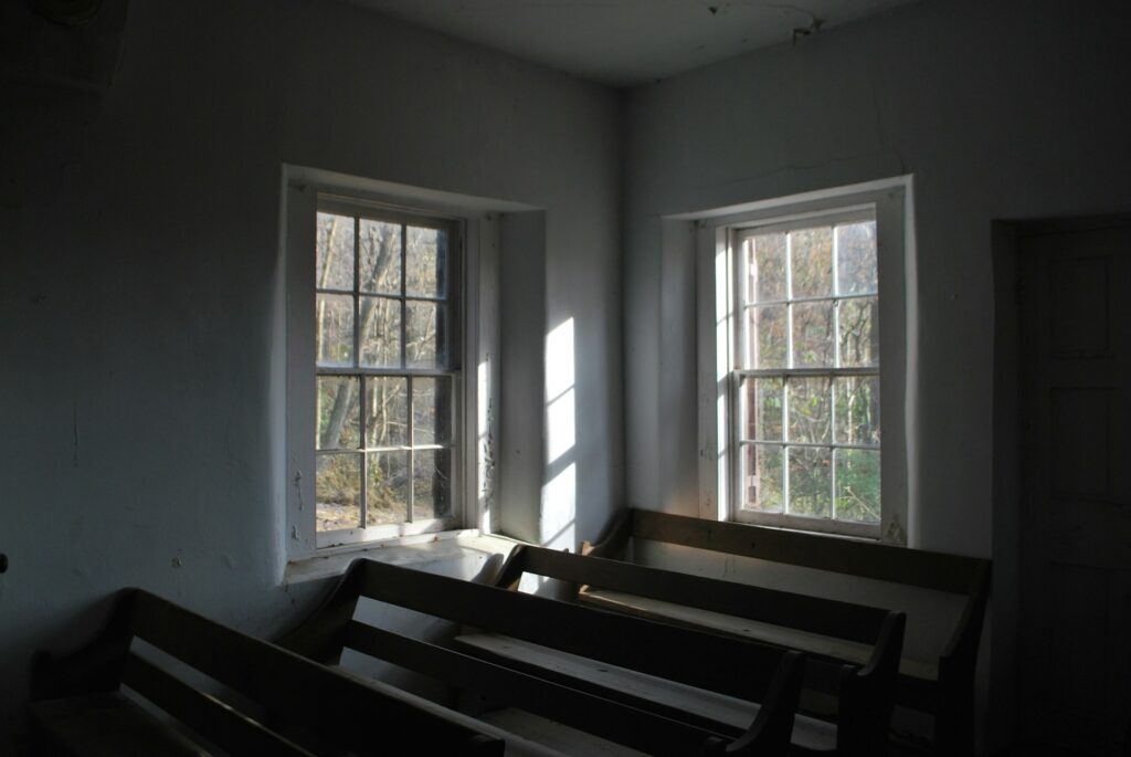 Faith in action: Quakers walk from NYC to D.C. for immigrant rights A very plain church with sparse wooden pews.
