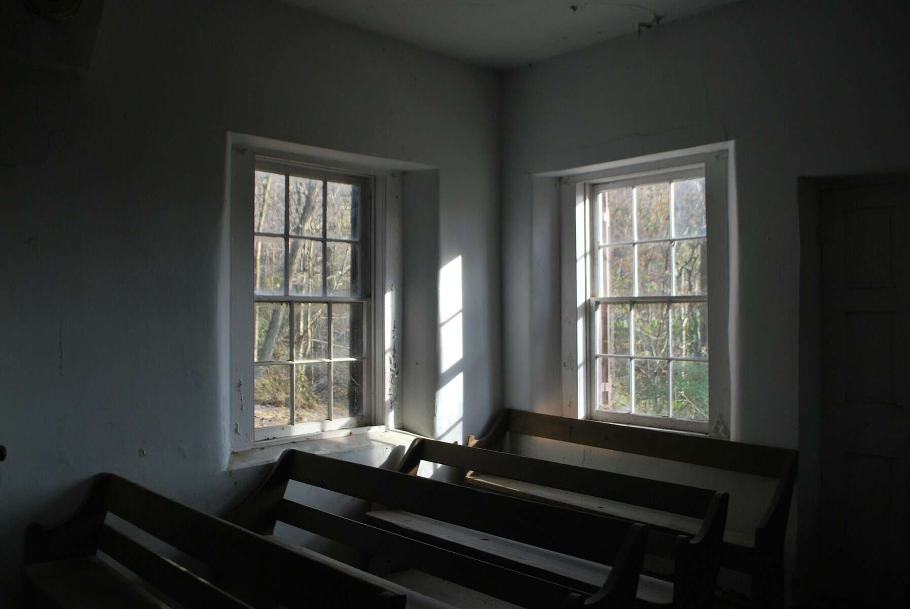 A very plain church with sparse wooden pews.