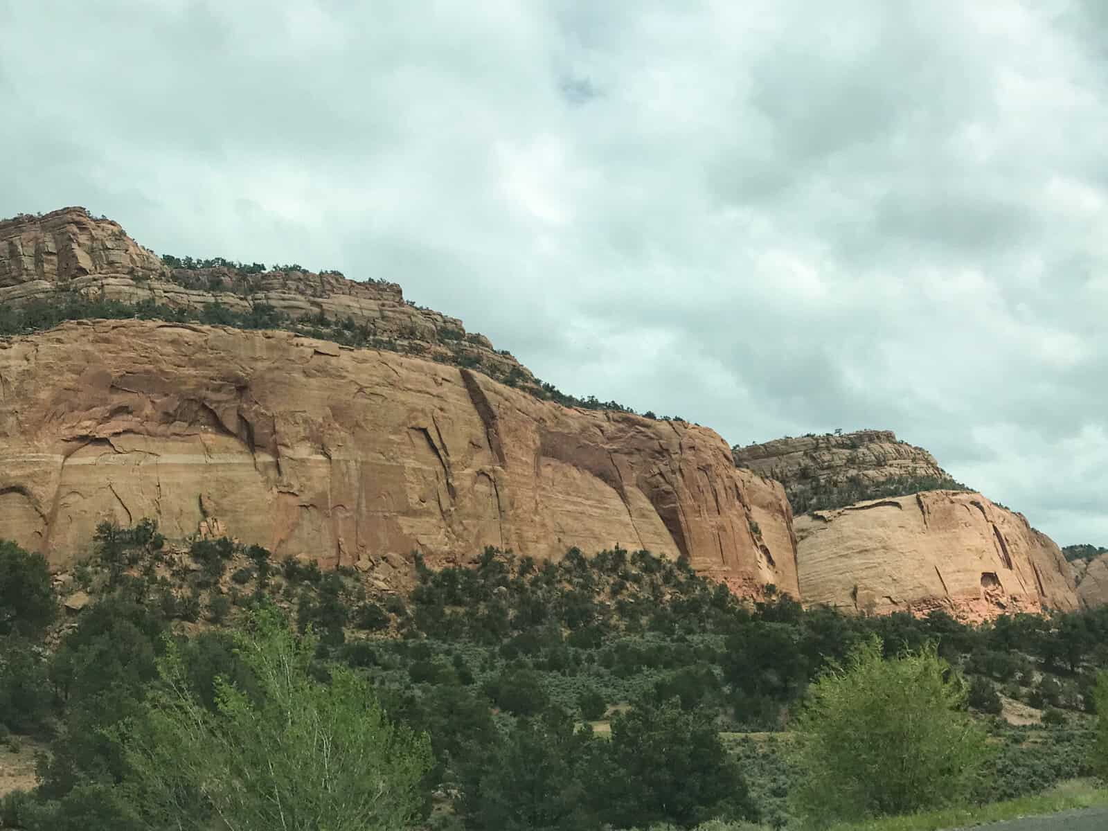 New Mexico rock formation with scrub below.