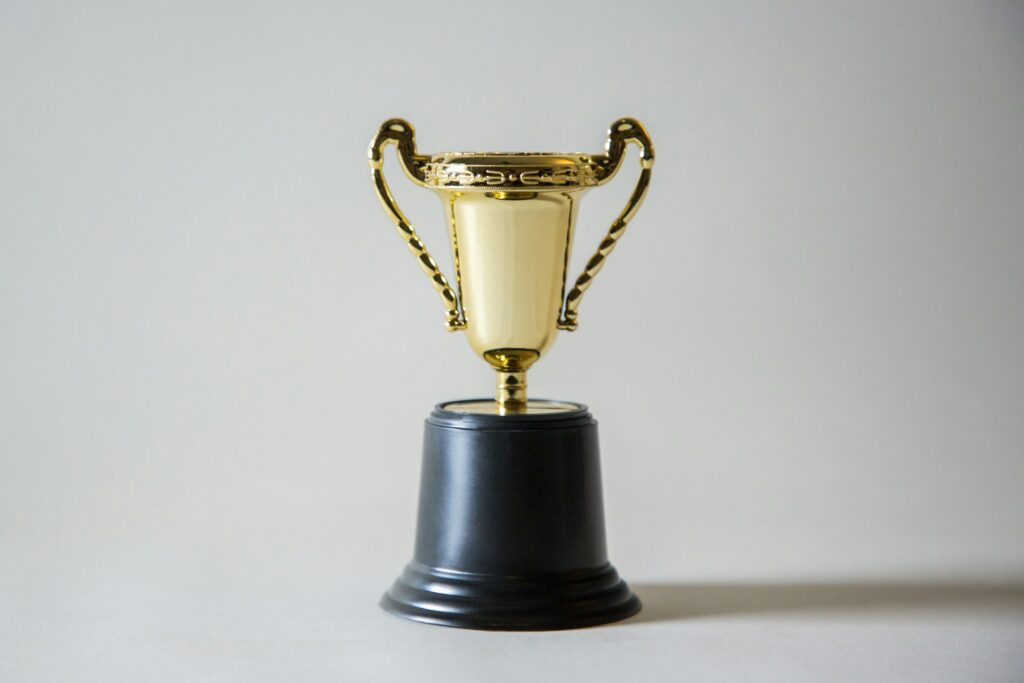 A gold trophy on a black base.