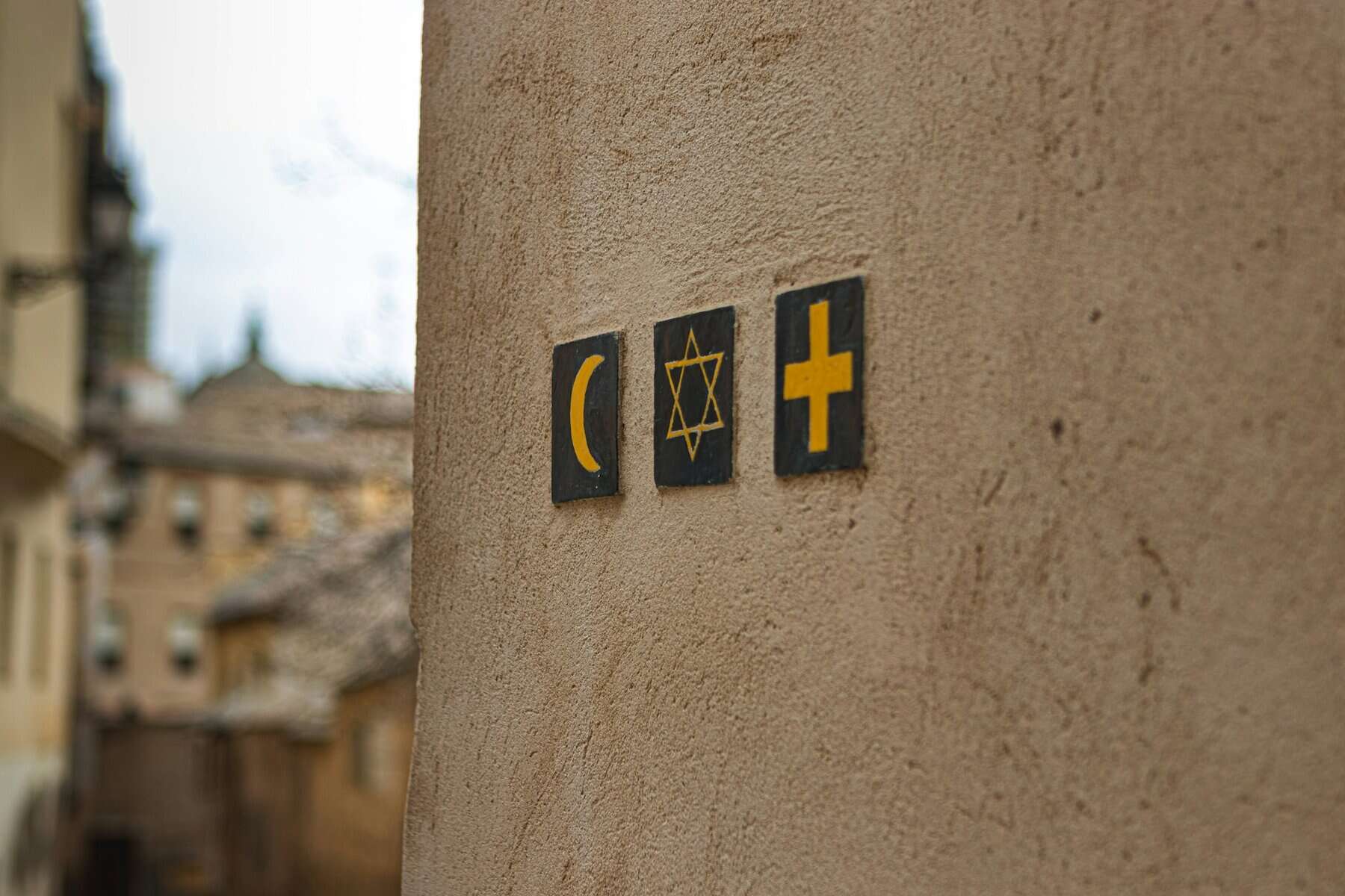 A stucco wall with religious symbols.