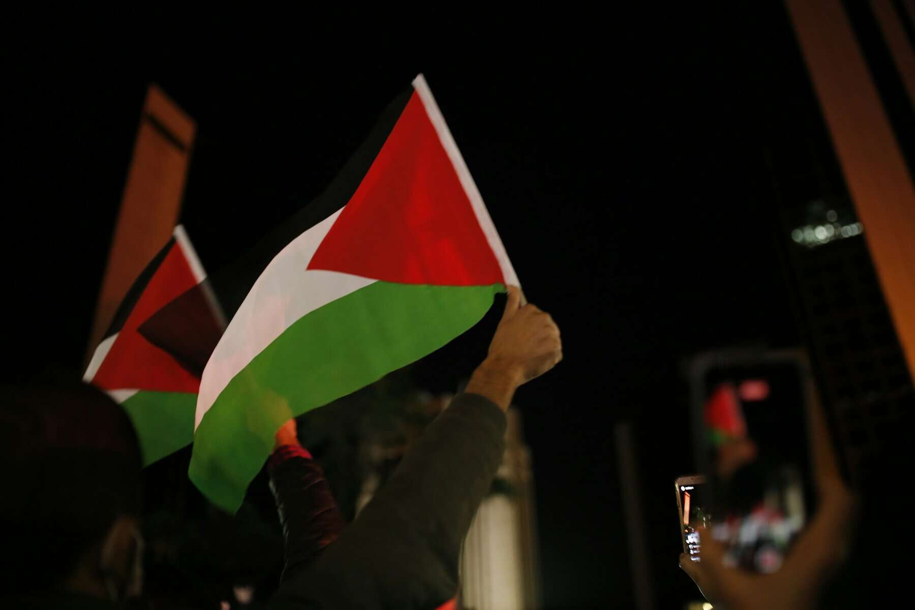 Flag of Palestine held up.