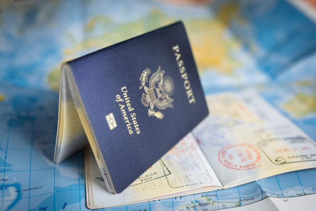 A passport standing on it's pages on a map.