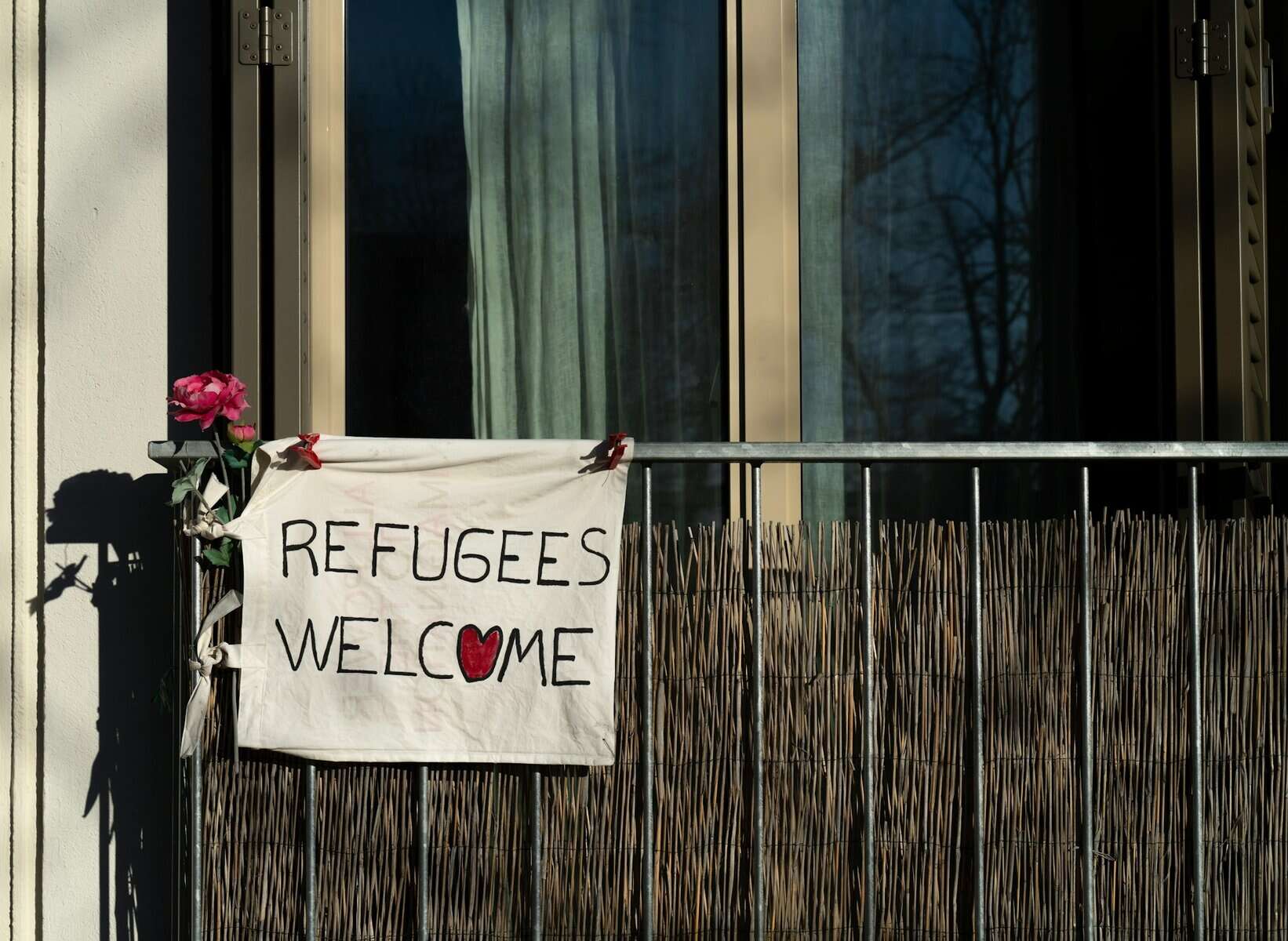 A sign says "Refugees Welcome"