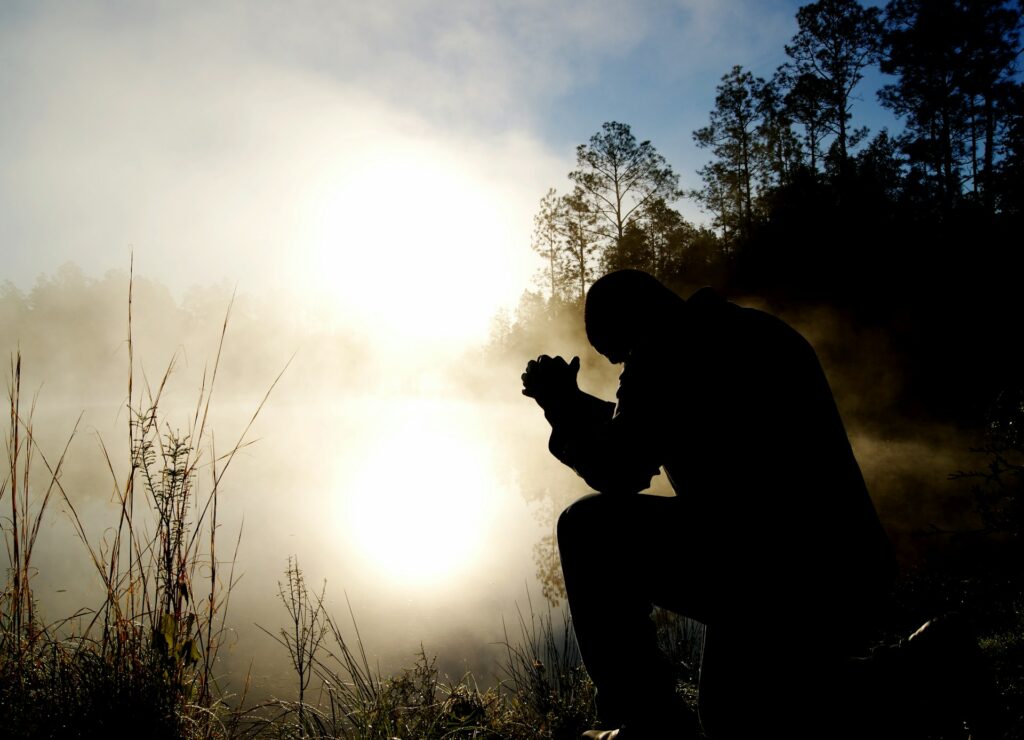 Ray Comfort rejects the Sinner’s Prayer as unbiblical A man sits with clasped hands and bowed head.