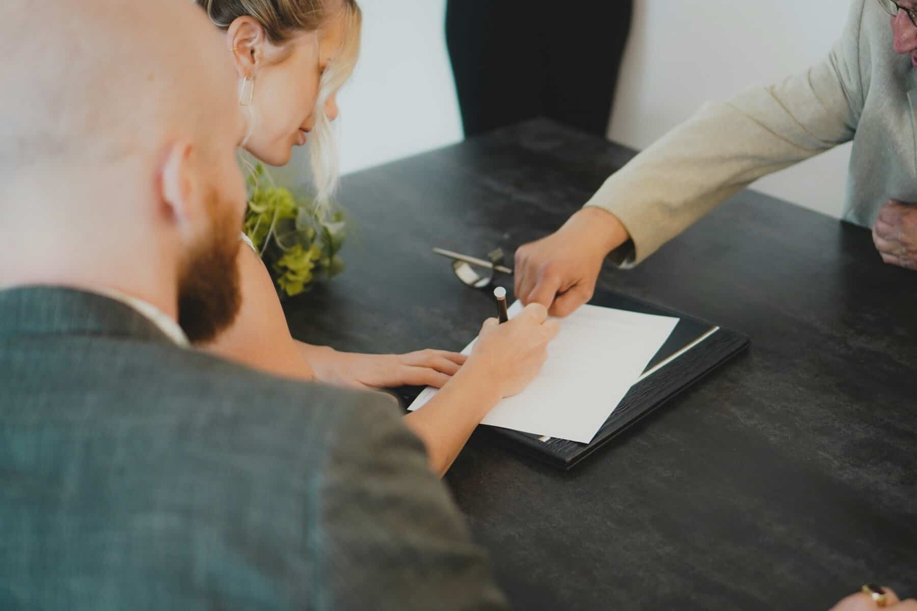 A woman signing a contract.