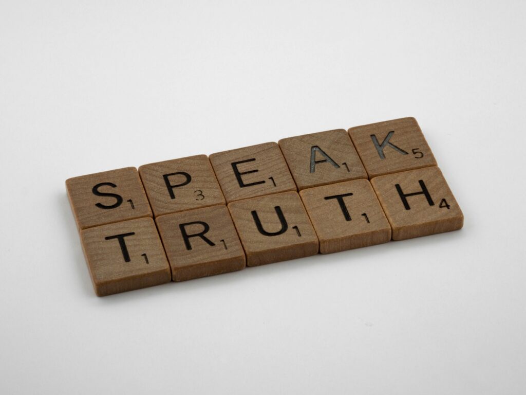 Republican Epstein survivors confront Trump’s “Democrat hoax” accusation Scrabble tiles say Speak Truth.