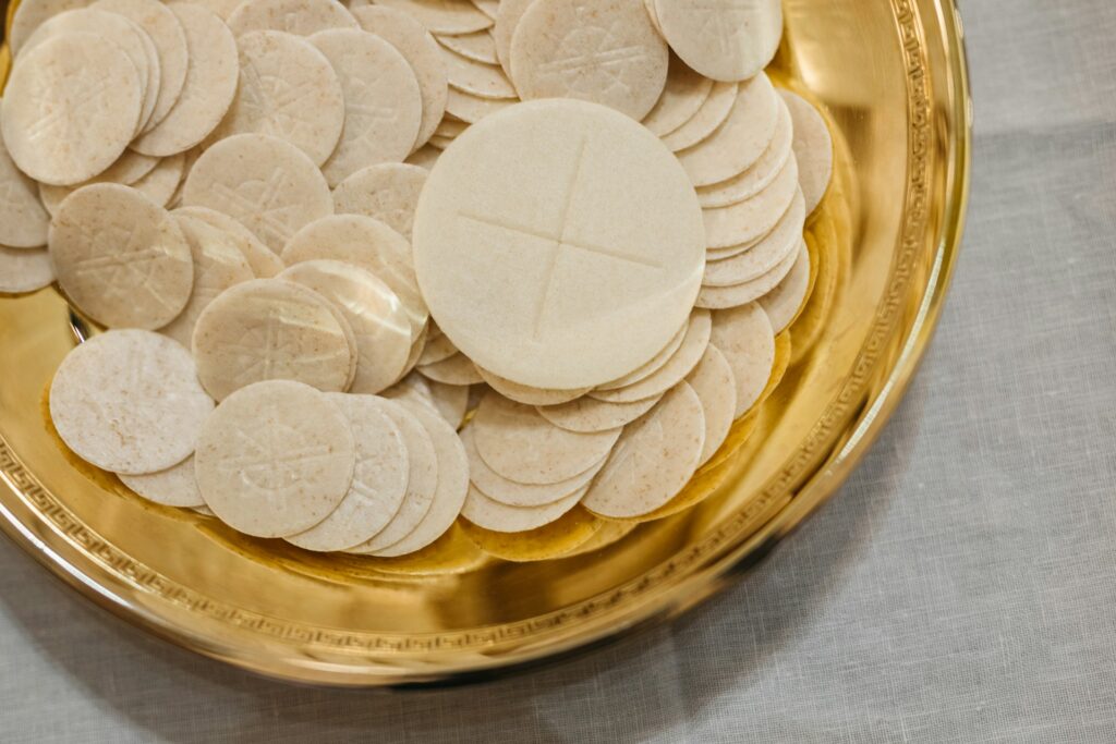 Communion wafers in a gold plate