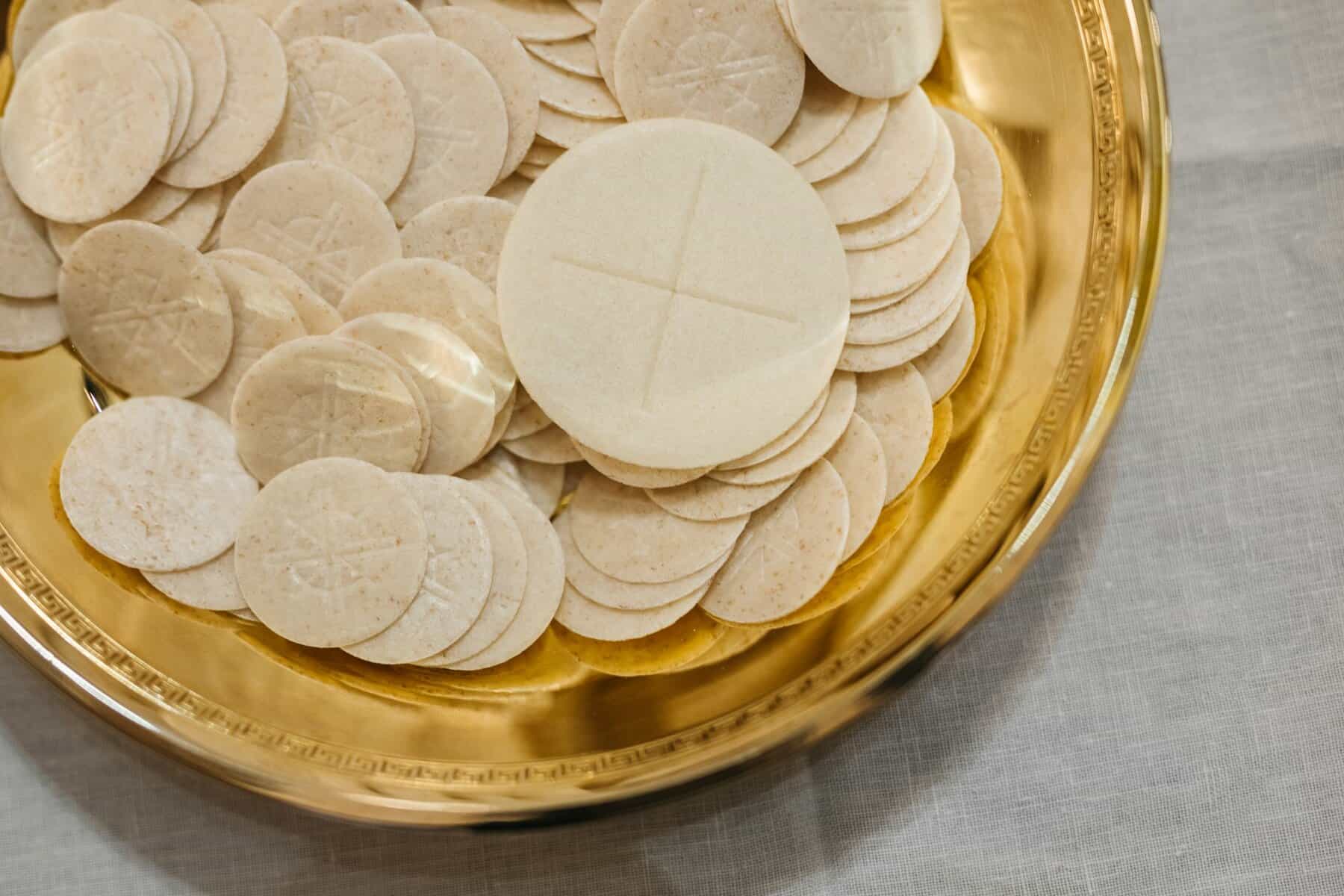 Communion wafers in a gold plate
