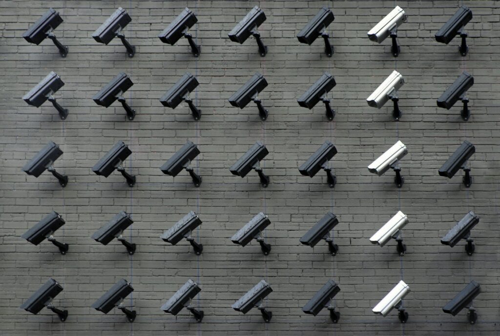 Lawmakers demand crackdown on American tech exports to China Rows of surveillance cameras on a brick wall.