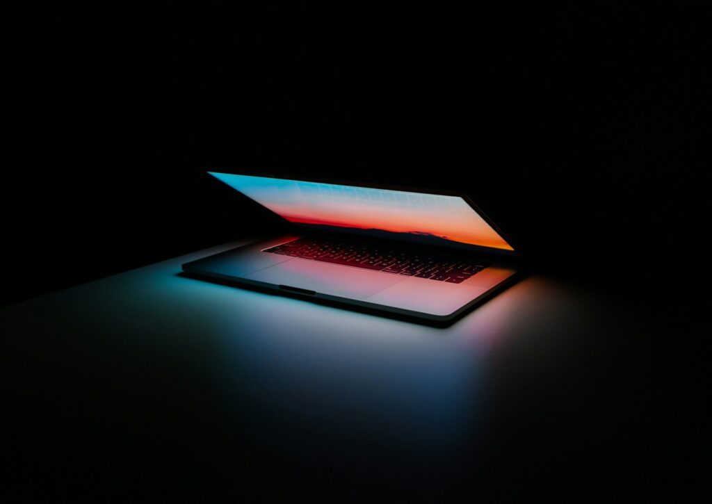 New ERLC guide urges faithful, cautious approach to Artificial Intelligence A laptop in a dark room slightly open with a colorful screen.