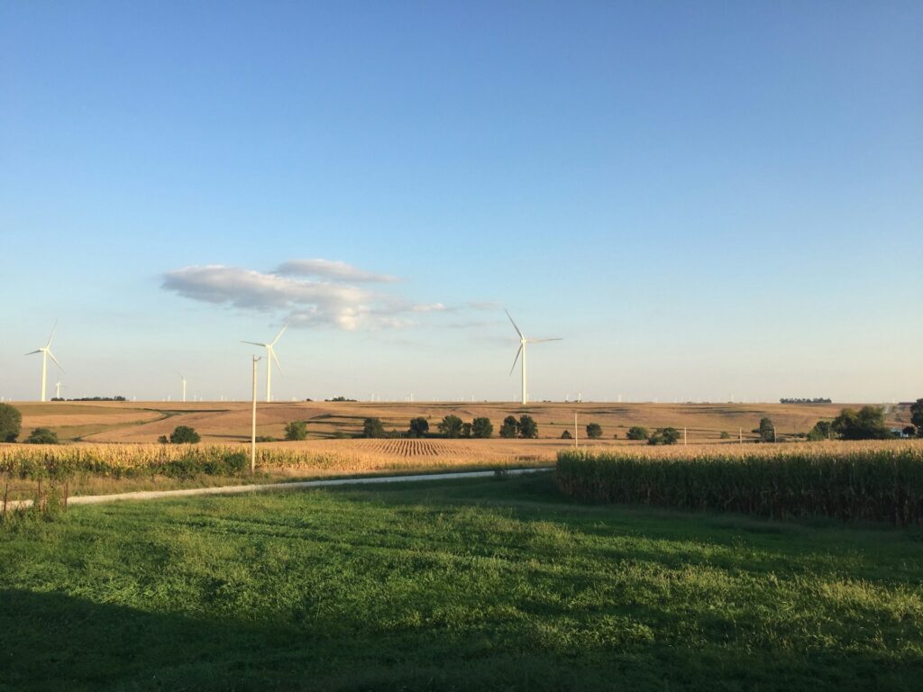 New York University President Timothy Westbrook outlines bold vision A view of plains with corn fields and wind turbines.