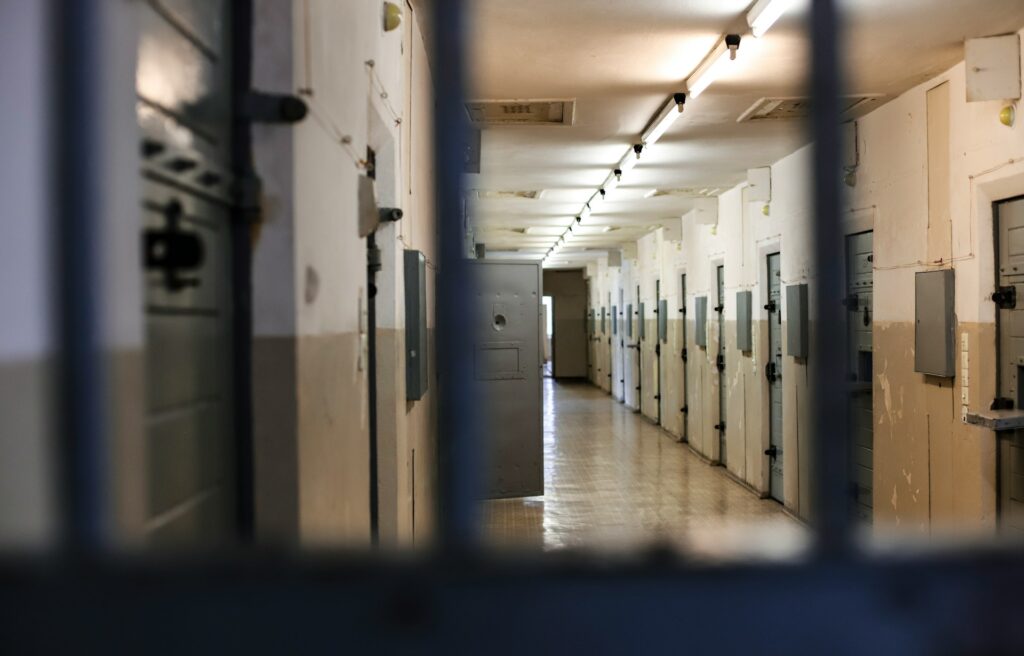 Jail cells seen through bars.
