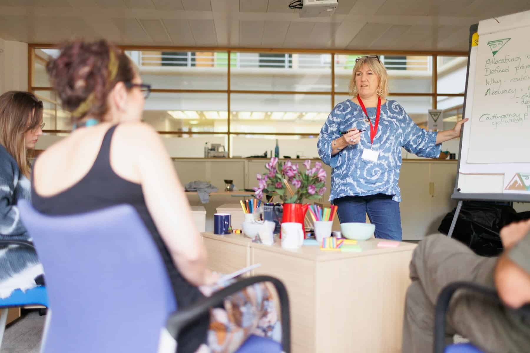 A woman speaking to other women.