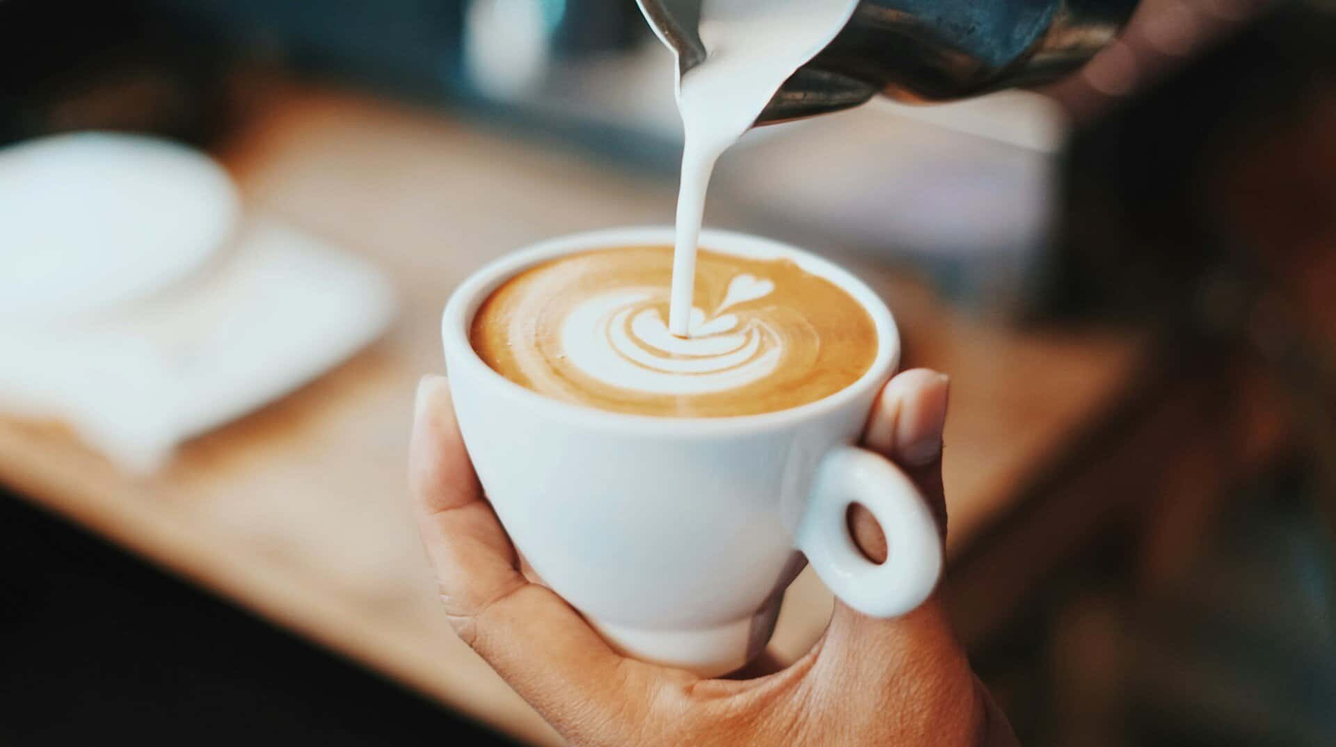 A person making a latte.