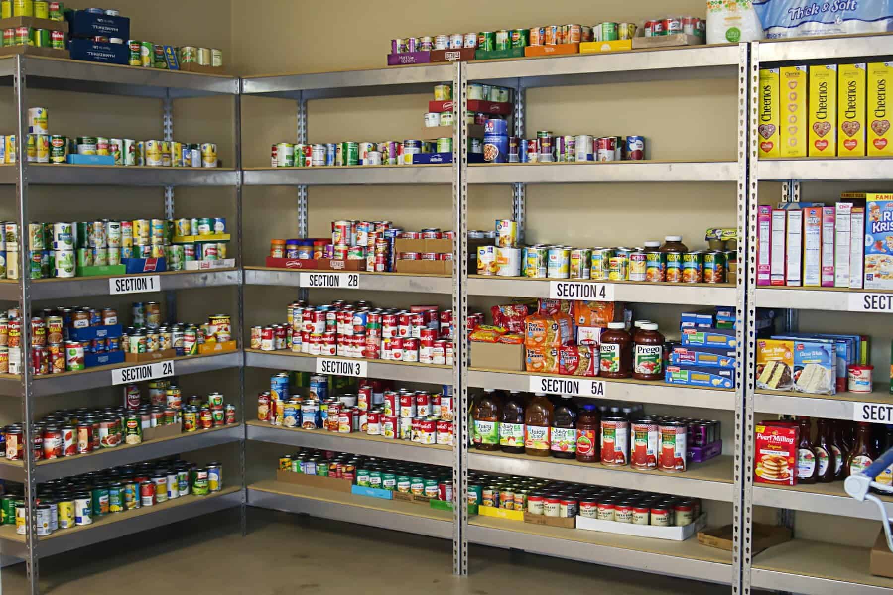 Food pantry shelves with a selection of items.