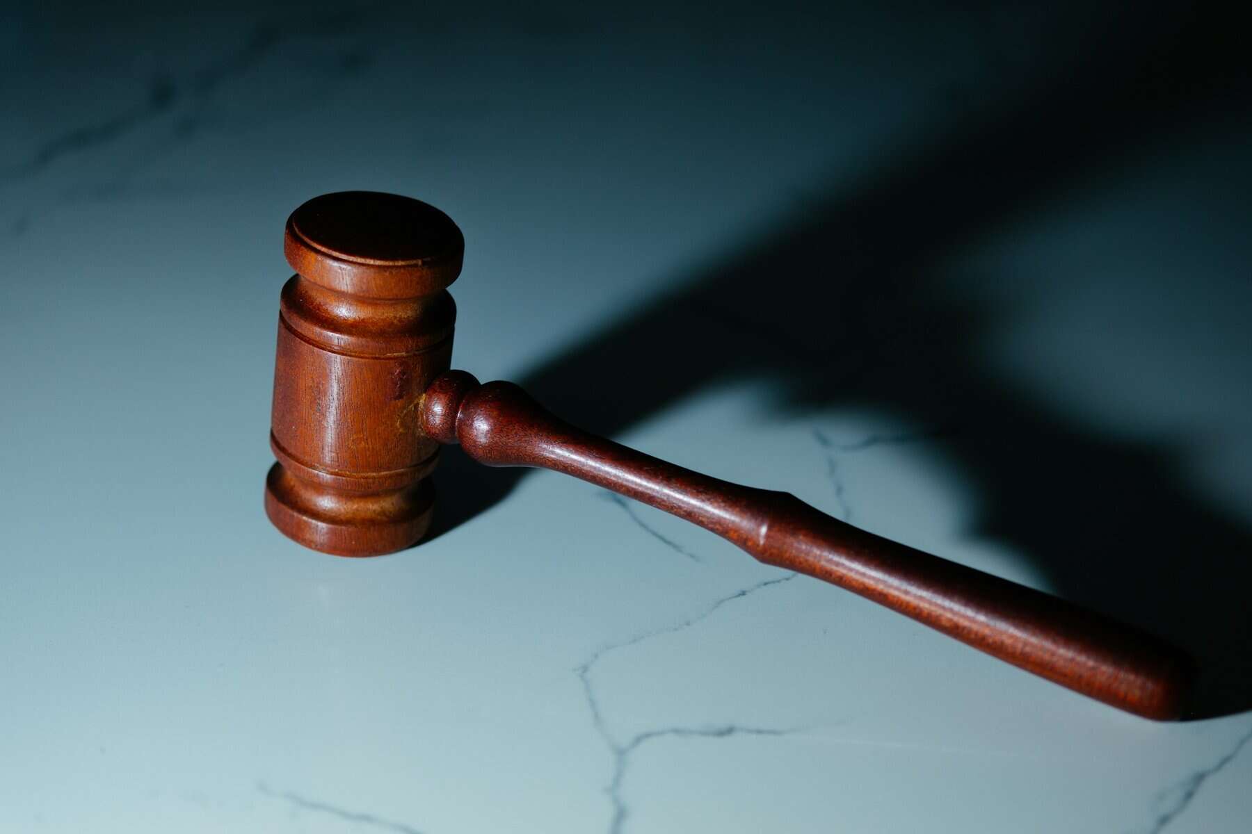 A judge's gavel on marble.