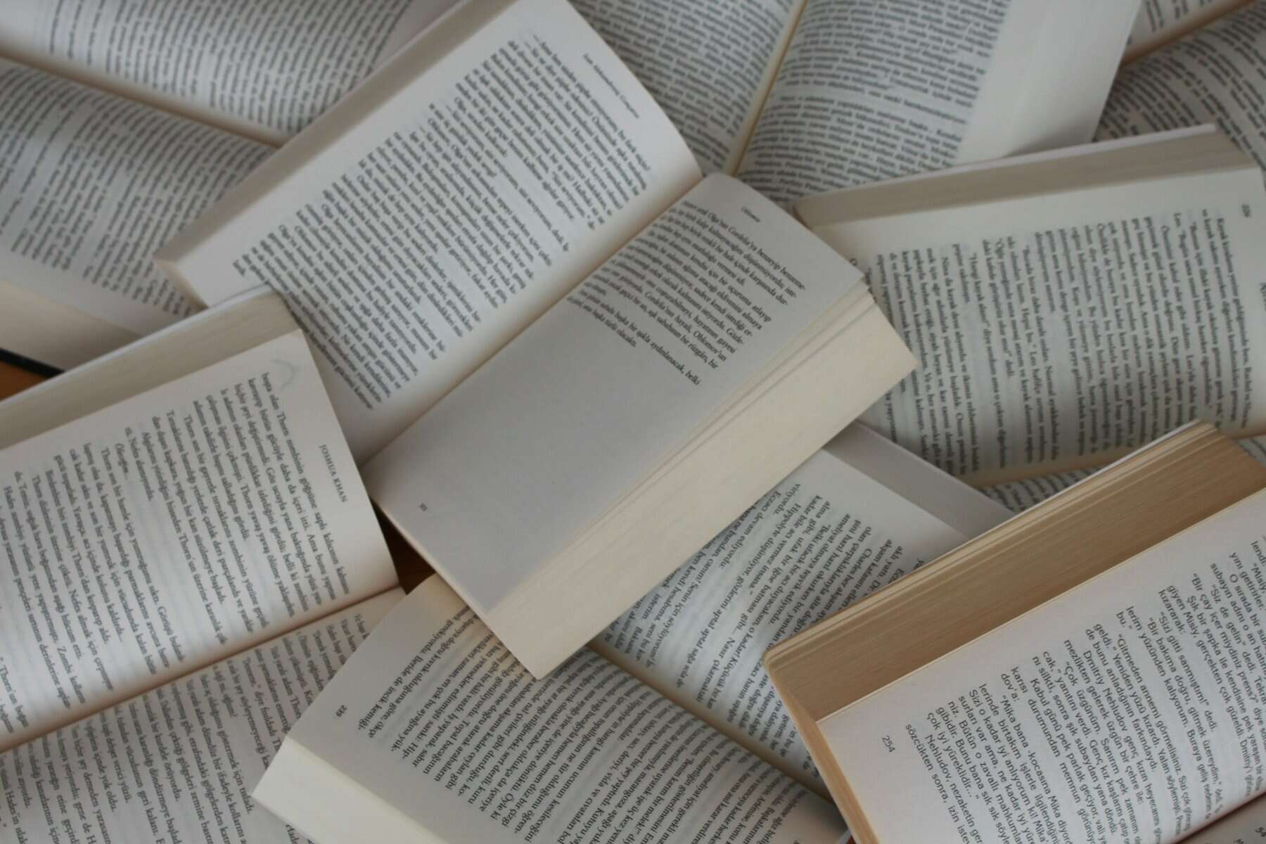 A stack of open faced books.