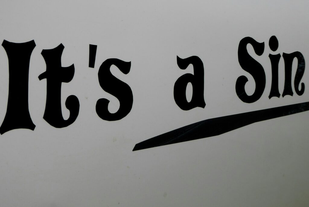 A sign with it's a sin written on it.