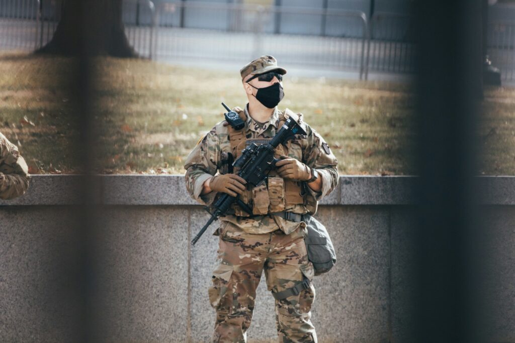 From Insurrection to Icon: The Ashli Babbitt martyr narrative A National Guardsman seen between fence bars.