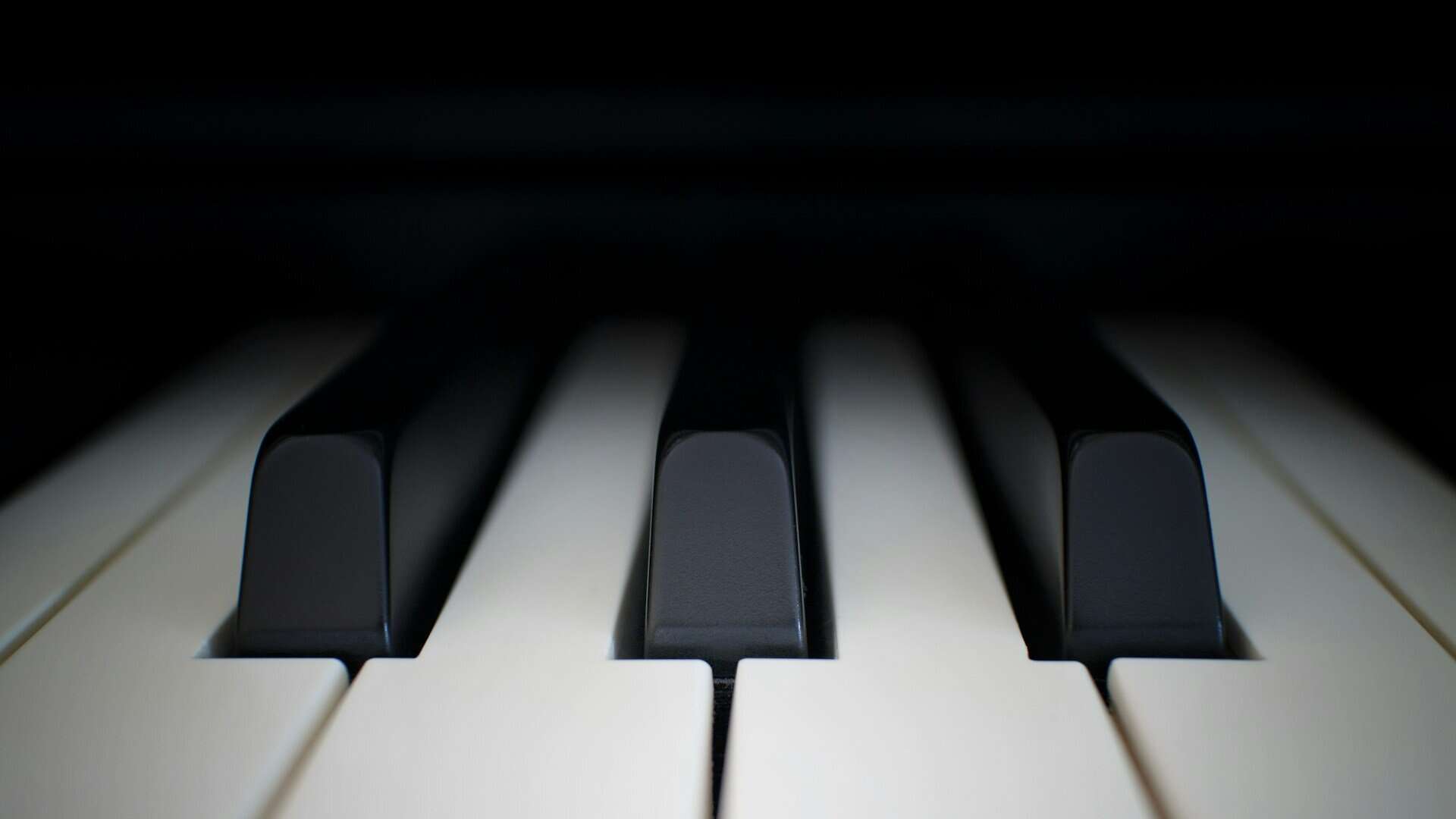 A very close up photo of piano keys.