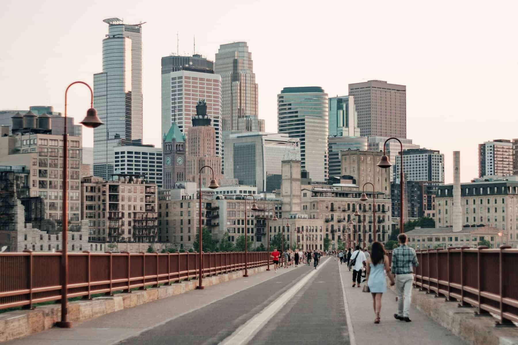 A skyline image with a pedestrian walkway of Minneapolis, MN