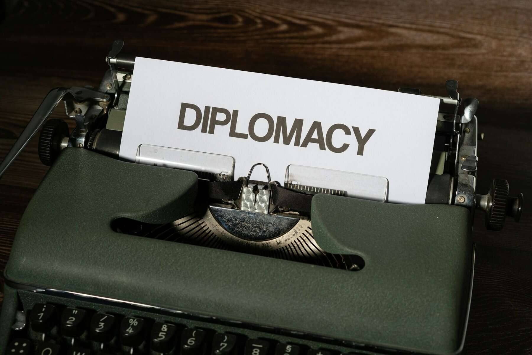 A green typewriter with a paper saying Diplomacy.